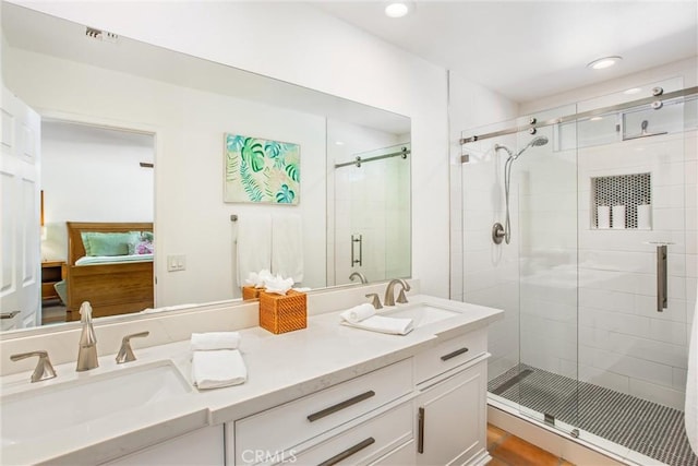 bathroom featuring vanity and an enclosed shower