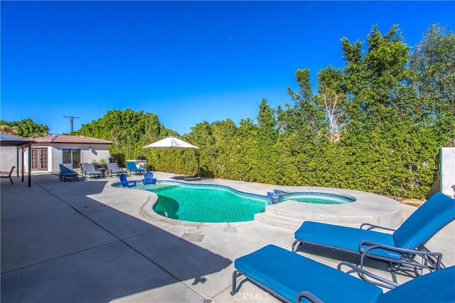 view of pool with a patio area and an in ground hot tub