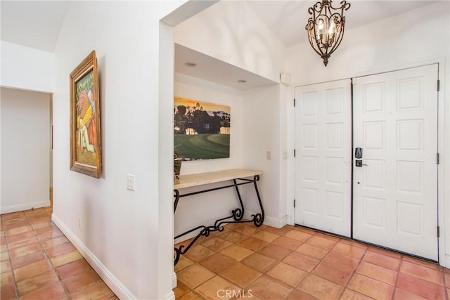 foyer entrance featuring a notable chandelier