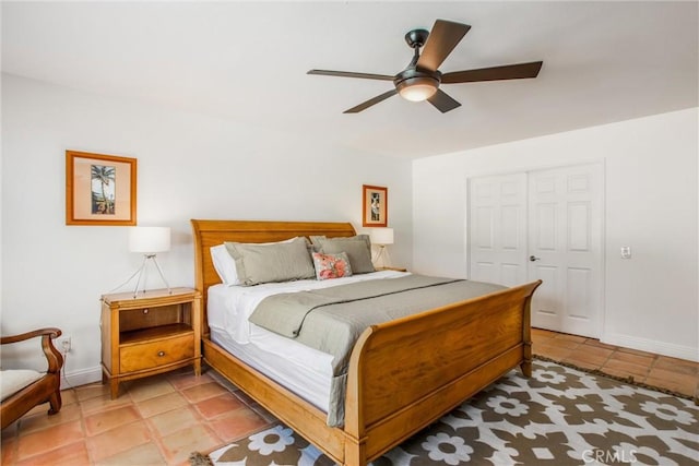 tiled bedroom with a closet and ceiling fan