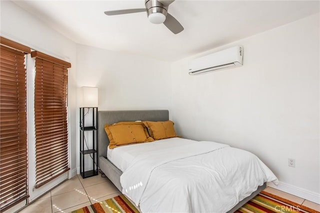 tiled bedroom with an AC wall unit and ceiling fan