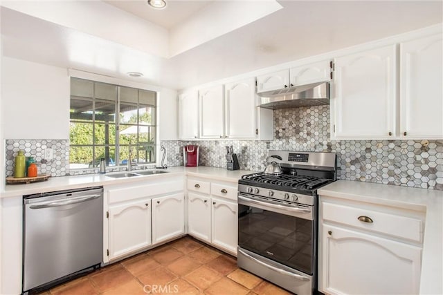 kitchen featuring stainless steel appliances, white cabinetry, tasteful backsplash, and sink