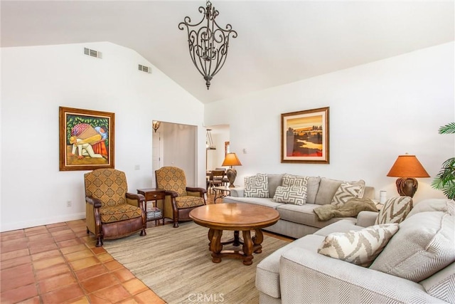 living room with a chandelier, light tile patterned floors, and vaulted ceiling