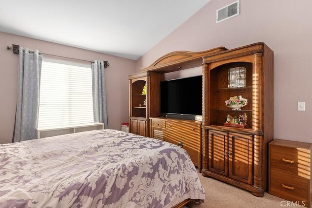 carpeted bedroom with vaulted ceiling