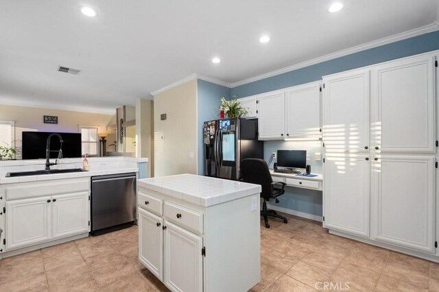 kitchen with dishwasher, tile counters, a kitchen island, black fridge with ice dispenser, and white cabinetry