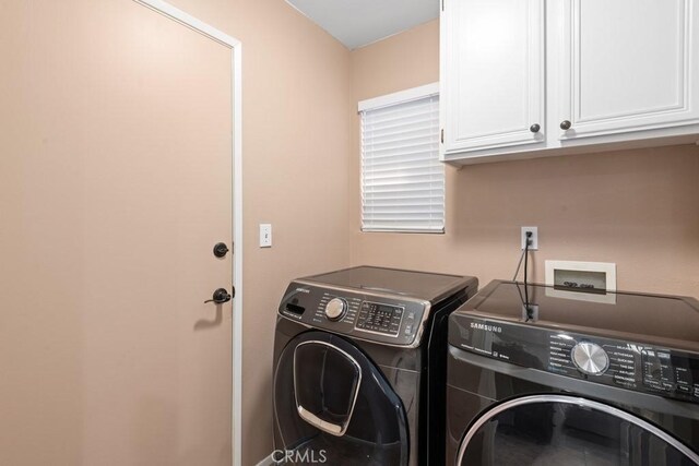 washroom with cabinets and separate washer and dryer