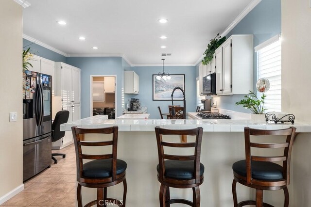 kitchen featuring kitchen peninsula, stainless steel refrigerator with ice dispenser, and white cabinets