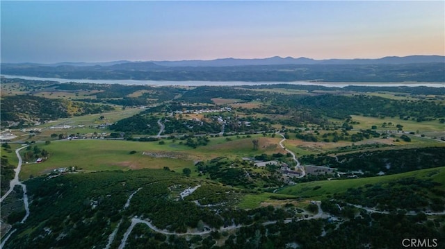 aerial view at dusk featuring a mountain view