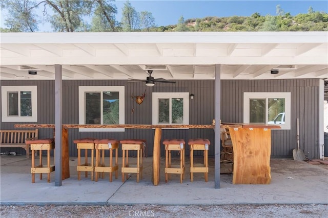 exterior space with a patio, ceiling fan, and exterior bar