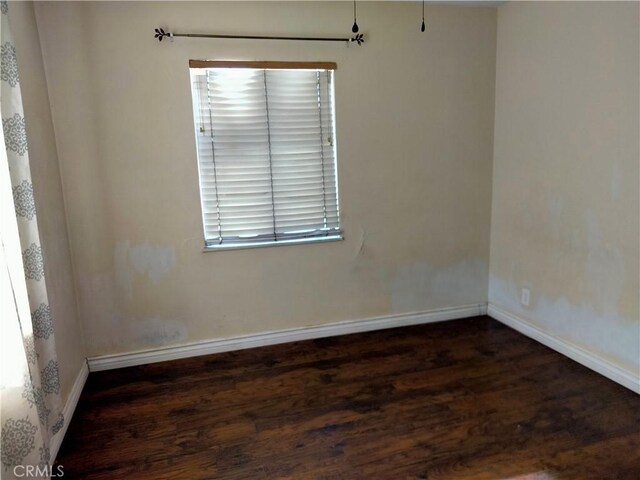 empty room featuring dark hardwood / wood-style floors