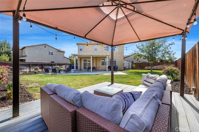 deck featuring outdoor lounge area, a yard, and a patio area