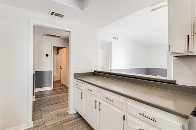 kitchen featuring white cabinets and light wood-type flooring