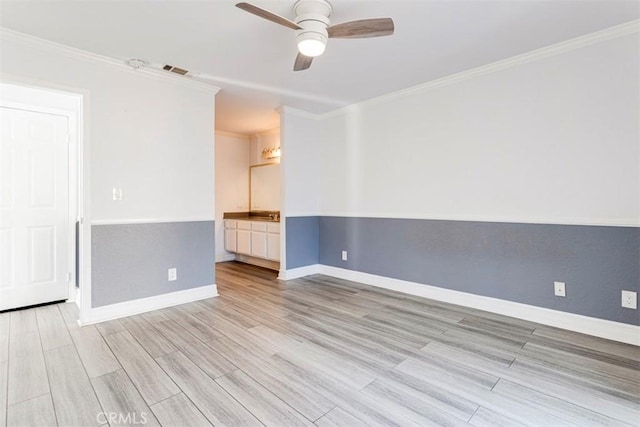 spare room featuring ceiling fan, light hardwood / wood-style flooring, and ornamental molding