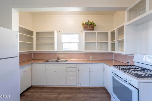 kitchen with white appliances, white cabinetry, and sink