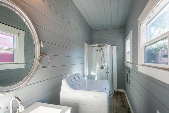 bathroom featuring walk in shower, wooden walls, and a wealth of natural light