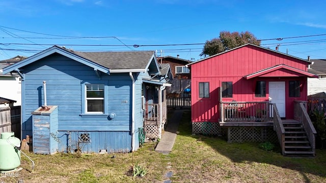 back of house featuring a yard and a deck