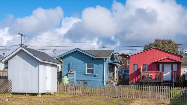 view of front facade featuring a storage unit and a deck