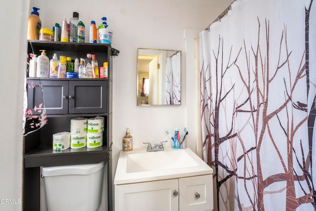 bathroom featuring toilet, a shower with curtain, and vanity