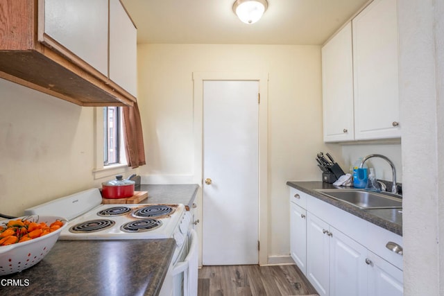 kitchen with wood-type flooring, sink, white range with electric stovetop, and white cabinets