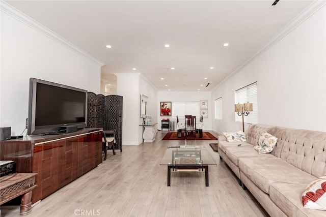 living room with light hardwood / wood-style floors and crown molding