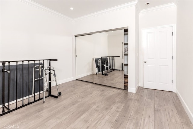 hallway featuring crown molding and light hardwood / wood-style floors