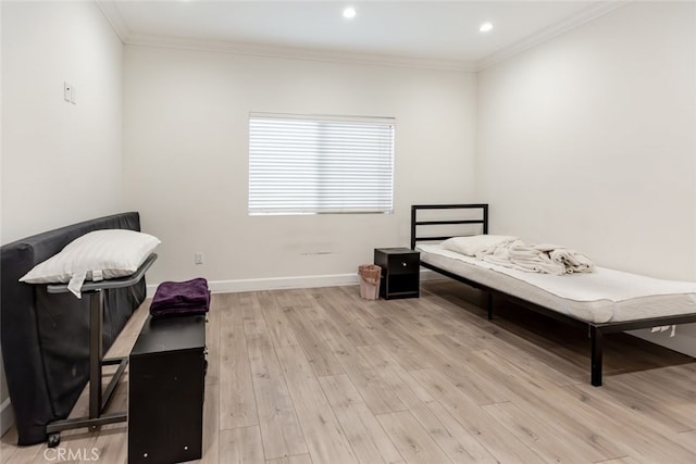 bedroom featuring light hardwood / wood-style flooring and crown molding