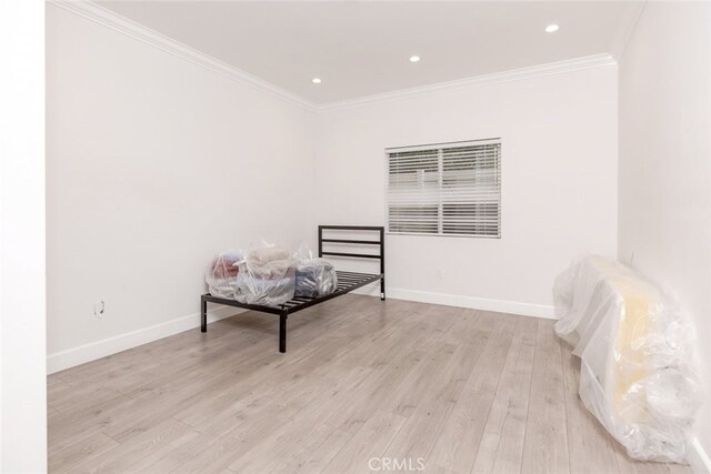 interior space featuring light wood-type flooring and crown molding