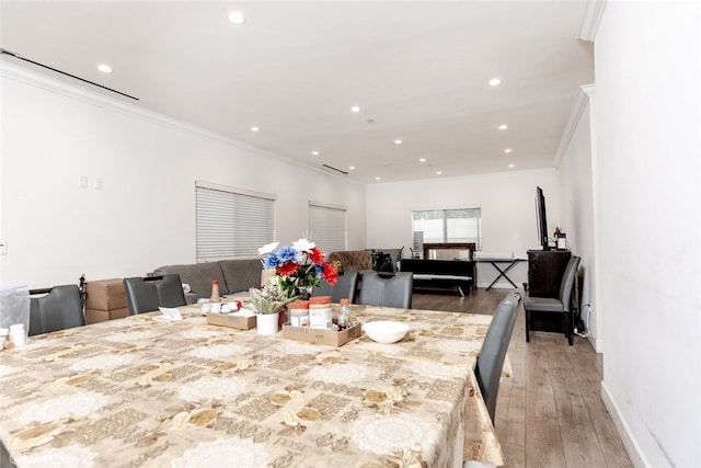 dining room featuring hardwood / wood-style floors and ornamental molding