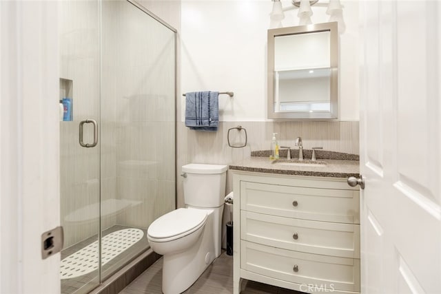 bathroom with vanity, toilet, and walk in shower