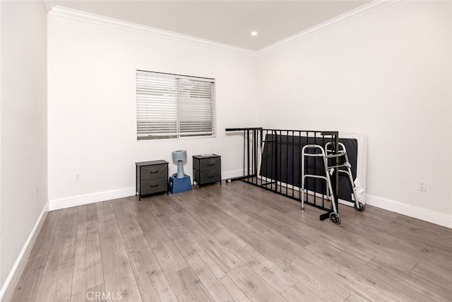 bedroom featuring light hardwood / wood-style flooring and ornamental molding