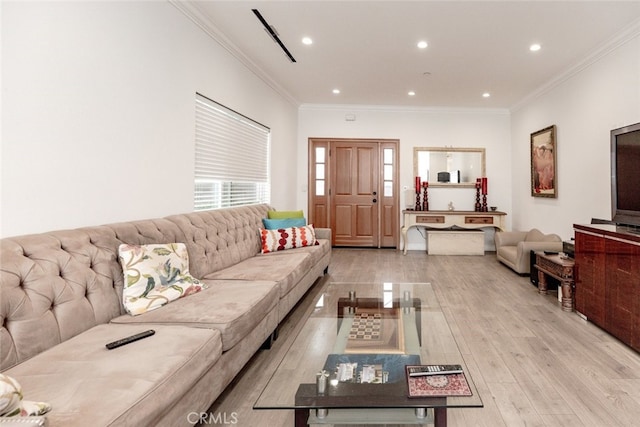 living room featuring light wood-type flooring and ornamental molding