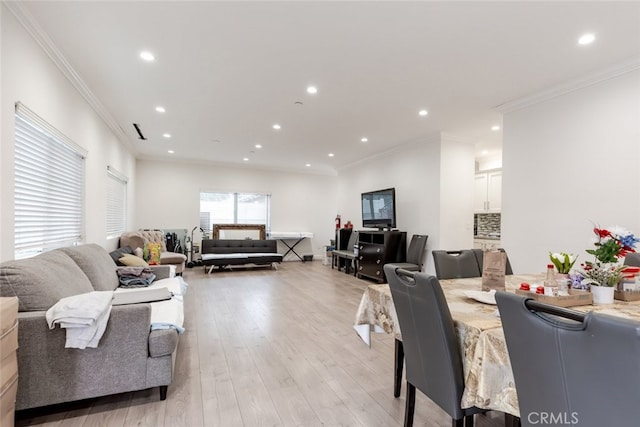 living room featuring light wood-type flooring and ornamental molding