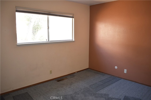 carpeted spare room with plenty of natural light