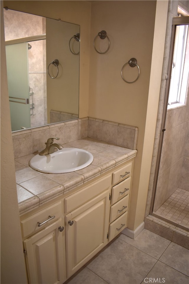 bathroom featuring vanity, walk in shower, and tile patterned floors