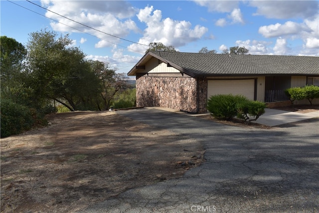 view of side of home featuring a garage