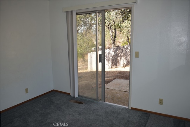 entryway featuring dark colored carpet