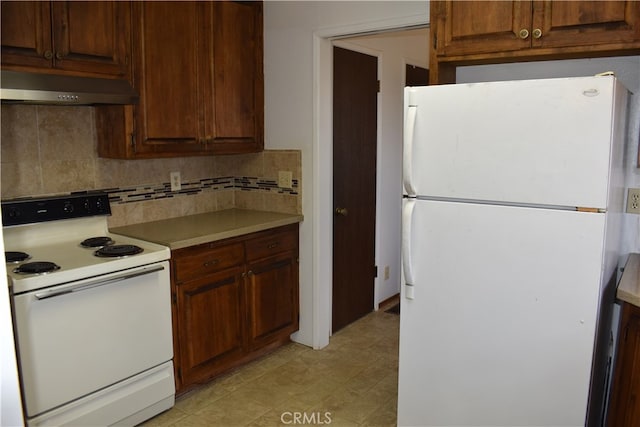 kitchen with tasteful backsplash and white appliances