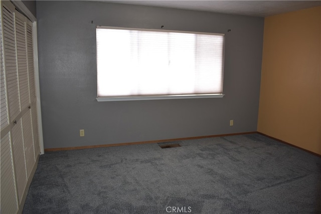 unfurnished bedroom with a closet and carpet floors