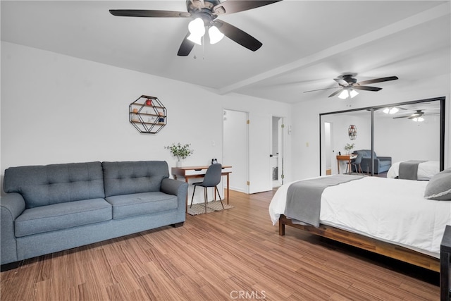 bedroom with light hardwood / wood-style floors and ceiling fan