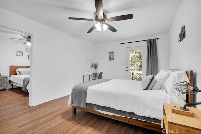 bedroom featuring ceiling fan, access to exterior, and hardwood / wood-style floors