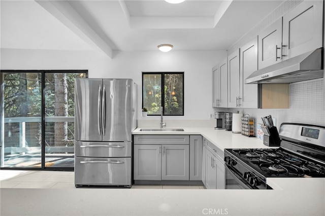 kitchen featuring appliances with stainless steel finishes, sink, plenty of natural light, and gray cabinets