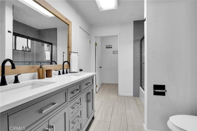 full bathroom with toilet, enclosed tub / shower combo, vanity, and tile patterned floors