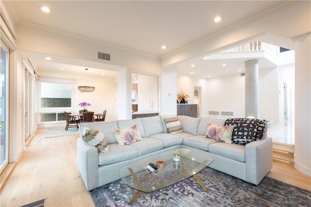 living room with crown molding and light wood-type flooring