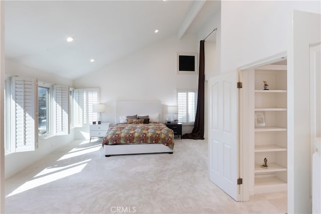 bedroom with light colored carpet and high vaulted ceiling