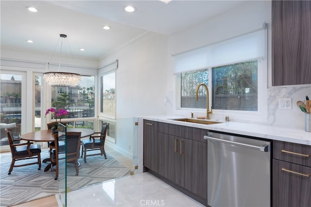 kitchen featuring sink, dishwasher, a wealth of natural light, and hanging light fixtures