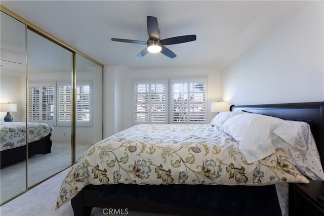 carpeted bedroom featuring a closet and ceiling fan