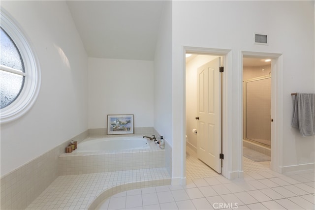 bathroom featuring separate shower and tub and tile patterned flooring