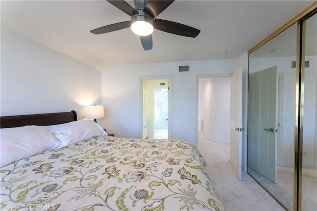 bedroom with a closet, light colored carpet, and ceiling fan