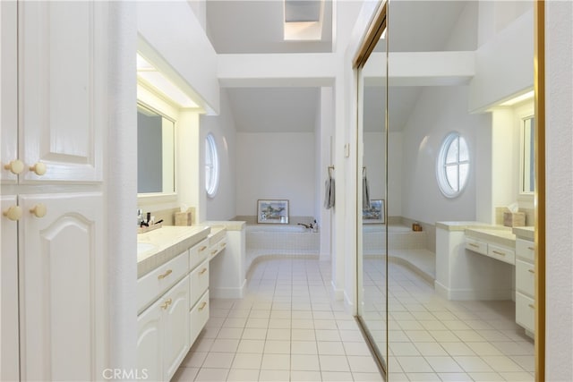 bathroom with vanity, lofted ceiling, and tile patterned flooring