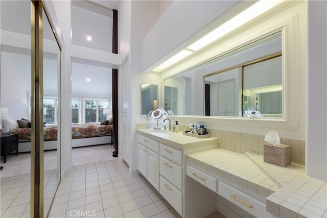 bathroom featuring vanity, decorative backsplash, and tile patterned flooring